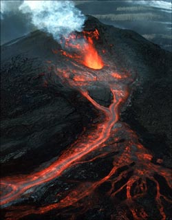 Photograph of Kilauea, the home of Hawaiian volcano goddess Pele, in eruption. Hawaiian chants and oral traditions tell in veiled form of many eruptions fomented by an angry Pele before the first European, the missionary Rev. William Ellis, saw the summit in 1823. The caldera was the site of nearly continuous activity during the 19th century and the early part of this century. Since 1952 there have been 34 eruptions, and since January 1983 eruptive activity has been continuous along the east rift zone. All told, Kilauea ranks among the world's most active volcanoes and may even top the list.