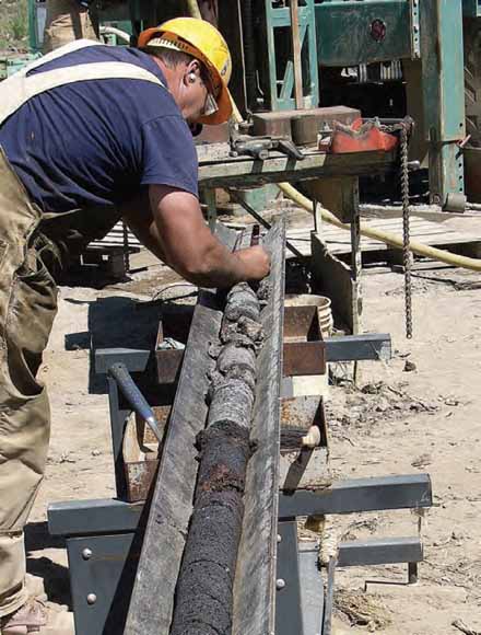 photo of man working with drill core