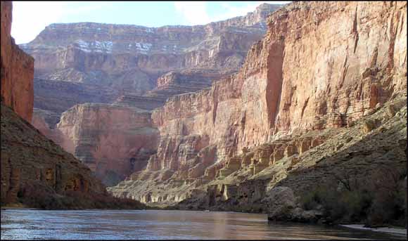 photo of river taken from down on the water looking up at a few thousand feet of cliffs