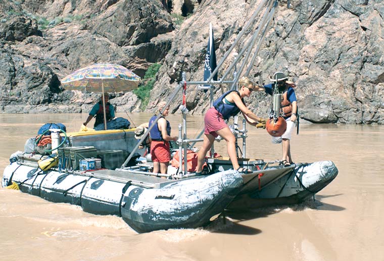 photograph of a raft deploying an underwater microscope system in the Colorado River