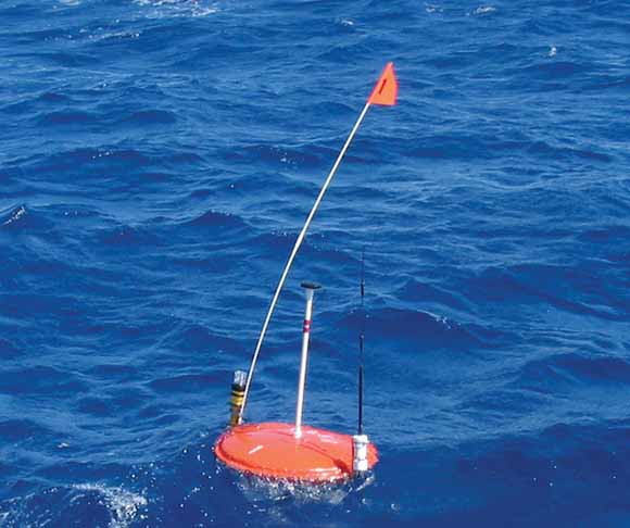 photograph of buoy-like device floating on the ocean surface