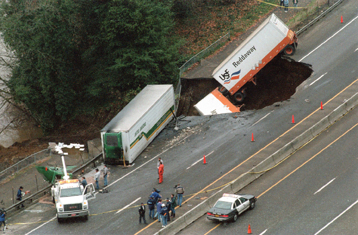Photo of trucks that wrecked when Interstate 5 washed out due to flooding.
