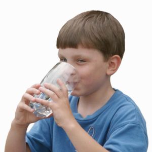 boy drinking water from a glass