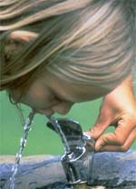 Figure 1 is a photograph showing a small child drinking at a fountain.