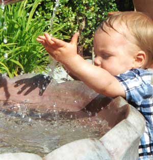 Figure 11 is a photograph showing a child playing in a birdbath.