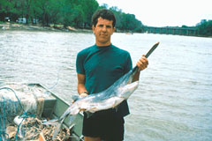 Man holding a paddlefish.
