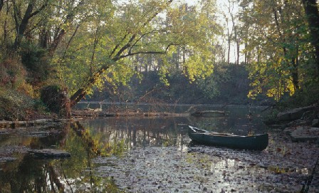 Photo showing canoe in stream.