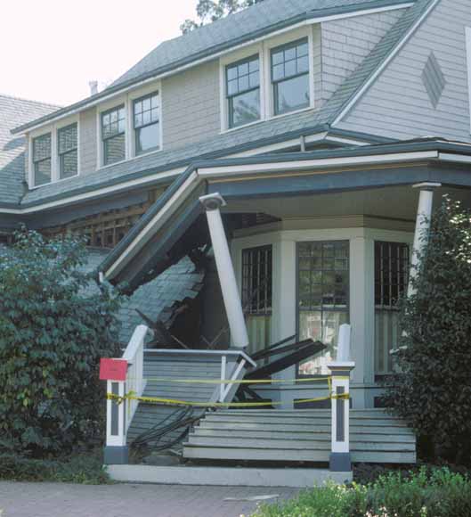 photo of house with porch fallen in blocking entrance
