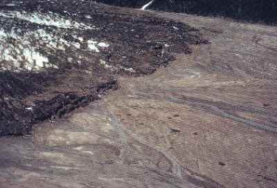 Figure 9a. Photo of a buried glacier ice front and buried ice blocks and the collapsed head of outwash and kettles  