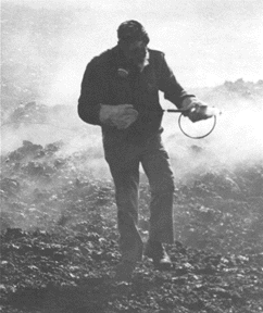 Photograph of scientist sampling volcanic gases at an active vent