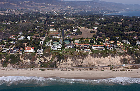 Photograph of heavily urbanized bluffs above Zuma Beach, California showing beach and hillside homes.