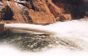 Open floodgates on the Glen Canyon Dam, Arizona, during a previous experimental flood.