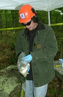 Jacobs Engineering geologist (Don Melcher) examining a retrieved well sample.