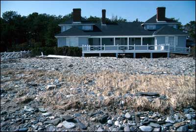 Cobble washover deposit and properties destroyed by waves and wave-hurled cobbles during the 1991 Halloween storm, Wells, Maine.