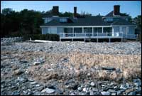 Cobble washover deposit and properties destroyed by waves and wave-hurled cobbles during the 1991 Halloween storm, Wells, Maine.