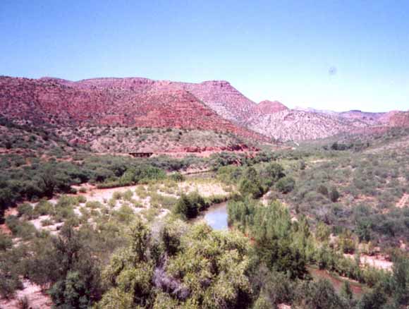 Cover photo showing red slopes in background and river in foreground