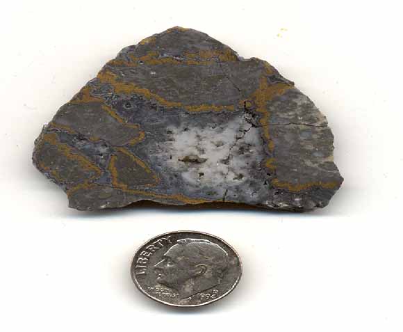 photo of gold-ore sample with dime for scale.  Sample is about three times the width of the dime