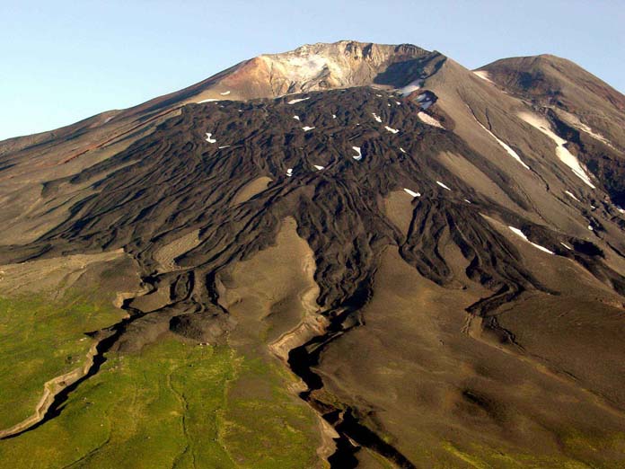 Gareloi Volcano, elevation 5,161 ft. (1,573 m), in the western Aleutian Islands, Alaska. Levied lava flows from an eruption in the 1980s drape the south flank of the southern crater.