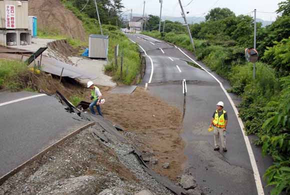 workers at collapsed road