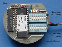 Figure 9. Photograph showing the timer board with the two block switches (mouse and time) used to program the Intervalometer. The current setting shown is for the 10-minute test mode. Switch 1 on the mouse block is in the on (upwards) position, and the remaining switches on the mouse and time blocks are in the off position.