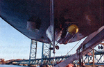 Thumbnail image of figure 7 and link to larger figure. A photograph of a sidescan sonar sensor mounted on the hull of launch 3102.