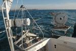 Thumbnail image of figure 9 and link to larger figure. A photograph of the Seabed Observation and Sampling System (SEABOSS) sitting on its deployment platform on the RV Rafael.