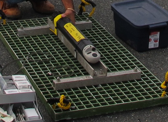 Thumbnail image of figure 5 and link to larger figure. A photograph of Nortek Aquadopp on grid platform