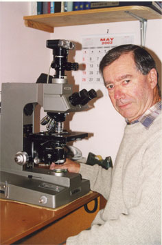 Stuart R. Stidolph at work with his beloved Olympus "Vanox" microscope. Phota taken in May 2002 by Jim Watt.