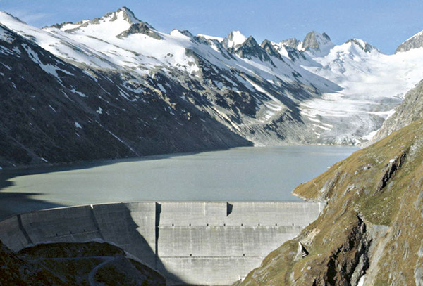 Figure 3-4.–View of dam on Oberaarsee (Lake Oberaar) and Oberaargletscher (Oberaar Glacier) in the background, Bernese Alps, Bern Canton, Switzerland, in September 1978. Photograph by Richard S. Williams, Jr., U.S. Geological Survey.