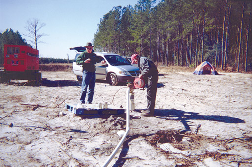 Photo of hydrologists taking  water-level measurements.