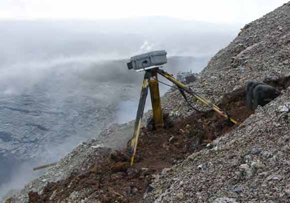 photo of a tripod-mounted camera looking like WallE viewing the caldera.