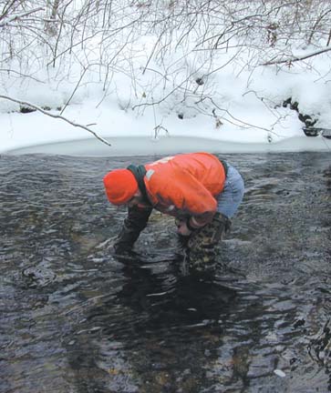 U.S. Geological Survey hydrologist collecting water samples.