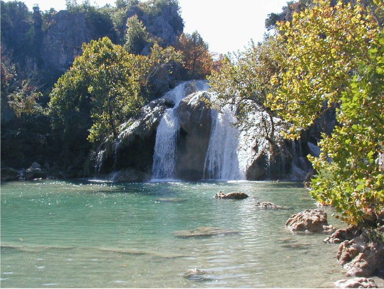 Figure 4. Photograph showing Turner Falls, the largest waterfall in Oklahoma, near
                        Davis, Oklahoma. Springs discharging from the Arbuckle-Simpson aquifer into Honey
                        Creek are the source of water to Turner Falls. Photograph by the U.S. Geological Survey.