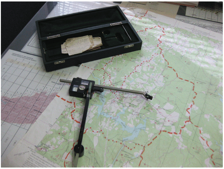 A planimeter used to compute drainage areas by following manually drawn drainage boundaries
                     on a topographic map.