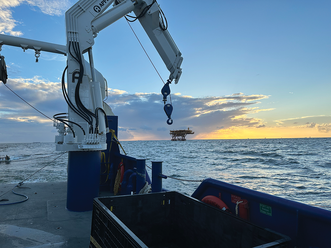 Stern view from the research vessel Pelican of oil platforms in the Gulf of Mexico, during a geophysical research effort to characterize
                        the sea floor offshore of the Mississippi River Delta front, September 2023.