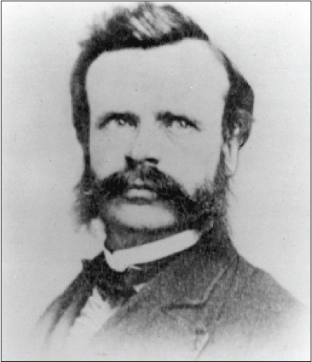 Black and white image of head and shoulders of man standing at a slight angle, face
turned toward the camera.