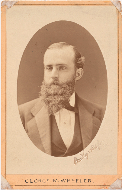 Portrait image of a bearded man in a suit.
