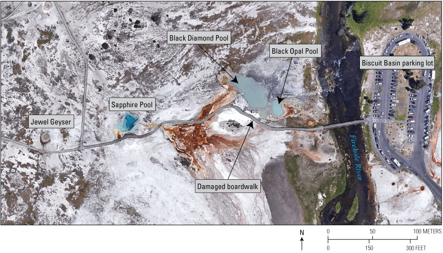 22. A barren landscape with a few blue pools, a river, and a parking lot.