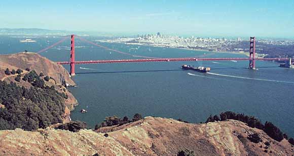 photograph of container ship entering San Francisco under the Golden Gate Bridge, taken from Hawk Hill