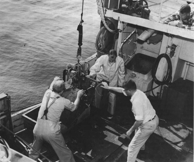 Figure 39. Photo of marine geologists preparing sampling buckets to study the sea floor, 1962.