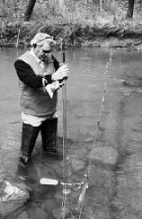 Man making water measurements.