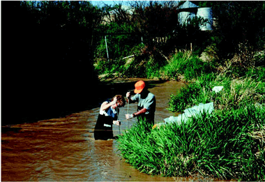 Sediment and water-quality sampling at Reed Wash. (Photograph by Norman Spahr, U.S. Geological Survey.)