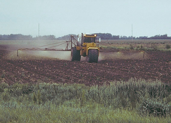 Photo of farmer spraying his field.