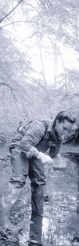 A woman taking a water sample.