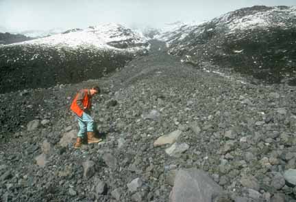 Photograph of flank of Crater Peak with geologist in foreground