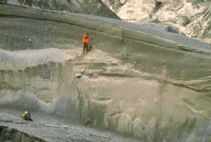Photograph of geologist on steep face cut into pyroclastic flow deposit