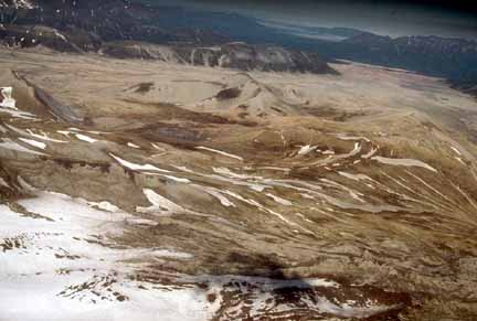Photograph of dome in middleground and ash-filled valley beyond