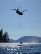 [Photo of helicopter lifting boat out of the water] 