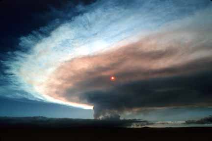 photo 029.  Wide-angle photo of tiny red sun behind volcanic cloud that has risen as a pillar then spread across the sky