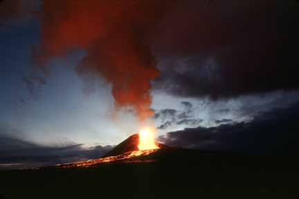 photo 030.  Distant, dusk photo of small volcano with yellow lava fountaining and red lava flowing towards photographer
